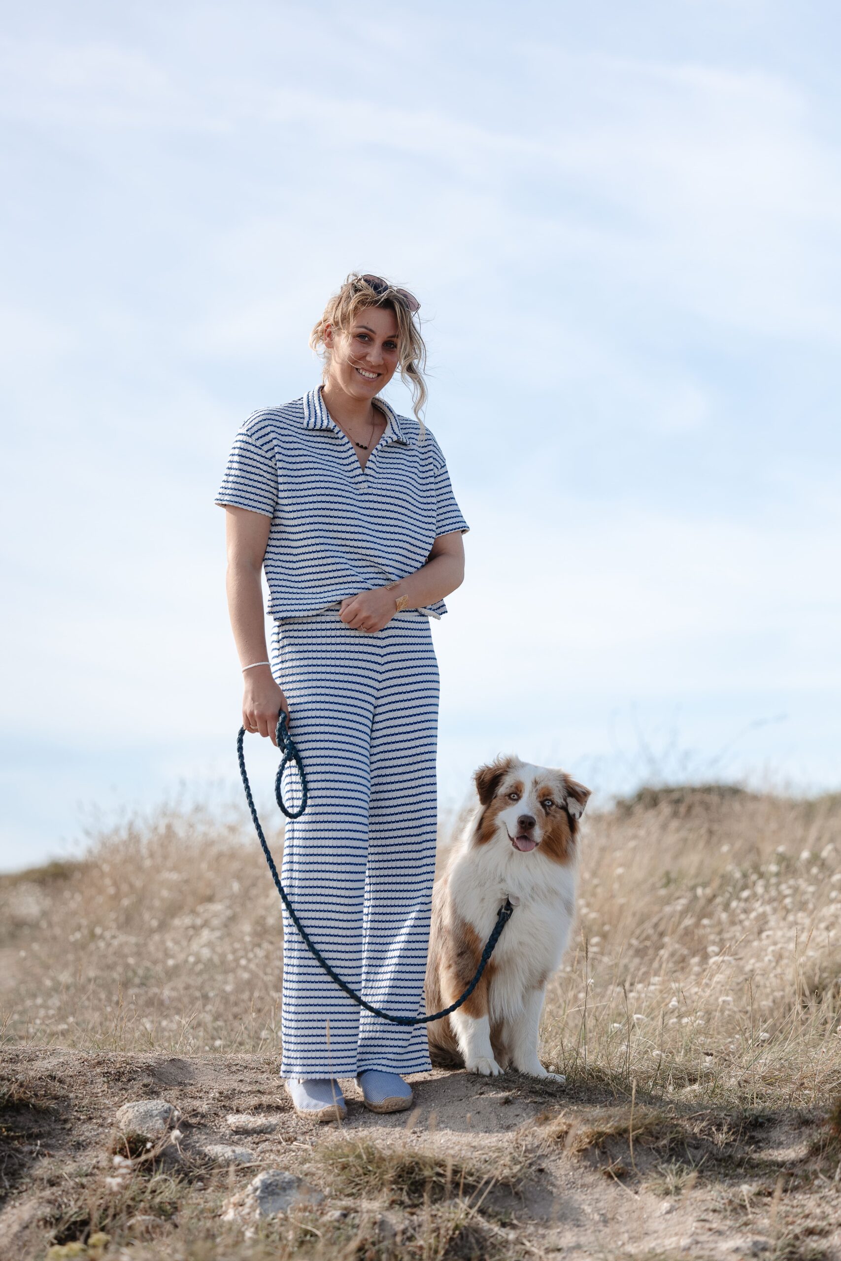 Jeu complice entre une femme et son chien sur la plage de Saint-Malo